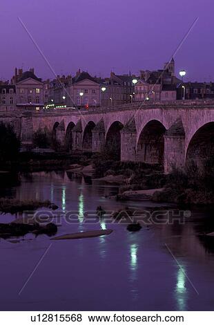 Stock Photo -  Loire Valley, France, Orleans, Loire Castle Region, Loiret, Centre, Europe, Reflection of the town of Orleans and the stone bridge in the Loire River in the evening.. Fotosearch