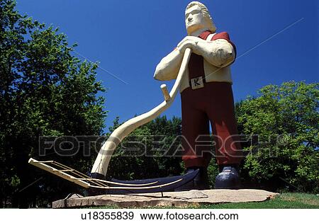 Stock Photo -  Manhattan, Flint Hills, KS, Kansas, A 30-foot statue of Johnny Kaw, a mythical Kansas wheat farmer at City Park.. Fotosearch