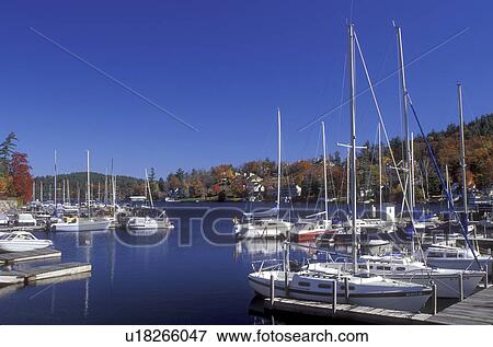 marina, Sunapee, NH, New Hampshire, Sailboats moored at a dock on the calm waters of Lake Sunapee in Sunapee in the autumn. View Large Photo Image Stock Photo - marina, Sunapee, NH, New Hampshire, Sailboats moored at a dock on the calm waters of Lake Sunapee in Sunapee in the autumn.. Fotosearch