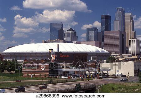 Stock Photograph -  Metrodome, Minneapolis, MN, Minnesota, Twin Cities, Hubert H. Humphrey Metrodome and downtown skyline of Minneapolis.. Fotosearch