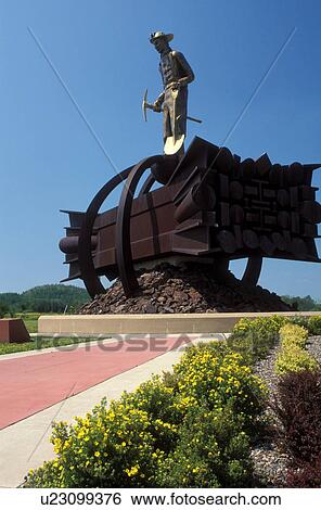 Stock Photograph -  mining, MN, Minnesota, Chisholm, Mesabi Iron Range, The Iron Man Memorial at the Ironwood Discovery Center.. Fotosearch