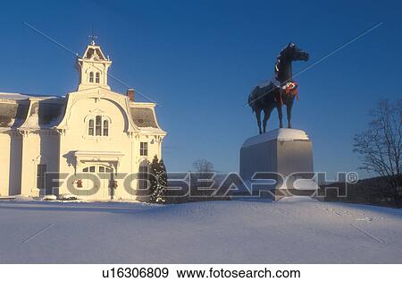 Stock Photo -  morgan horse, UVM Morgan Horse Farm, barn, snow, winter, decorations, A statue of a Morgan Horse, America's first breed of horse, is decorated with a red bow for Christmas in front of the white barn at the University of Vermont Morgan Horse Farm in Middl. Fotosearch
