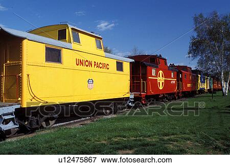 Stock Photo -  motel, caboose, hotel, Strasburg, Lancaster County, Pennsylvania Dutch Country, Amish Country, Pennsylvania, Colorful red and yellow (Union Pacific and Santa Fe) cabooses at The Red Caboose Motel in Strasburg.. Fotosearch