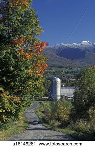 Stock Image -  mountain, snow, country road, farm, Fletcher, VT, Vermont, Mt. Mansfield, Scenic view of the first snow on Mount Mansfield in the fall and the picturesque countryside from a country road in Fletcher.. Fotosearch