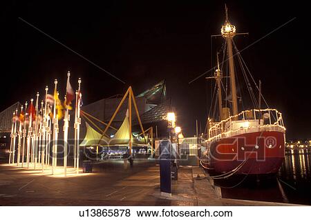 Stock Photo -  National Aquarium, Inner Harbor, Baltimore, MD, Maryland, Lightship Chesapeake and the National Aquarium at the Inner Harbor in downtown Baltimore in the evening.. Fotosearch