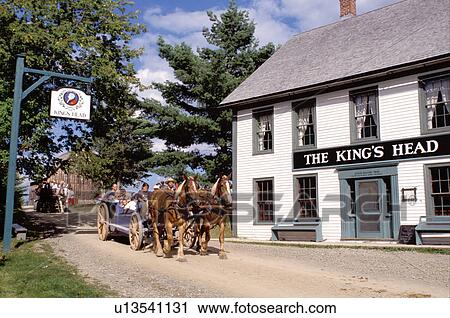 Stock Image -  New Brunswick, NB, Canada, Wagon rides at King's Landing Historical Settlement next to King's Head Inn.. Fotosearch
