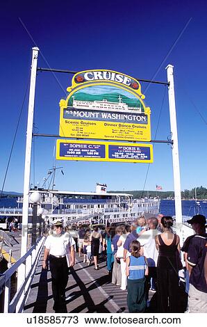 Stock Image -  New Hampshire, Weirs Beach, NH, Passengers standing in line waiting to board the M. S. Mt. Washington Cruise Boat on Lake Winnipesaukee.. Fotosearch