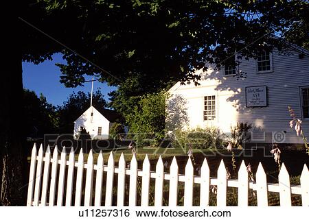 Stock Photograph -  New Hampshire, Wolfeboro, NH, Clark House ca. 1778, Wolfeboro Historical Society next to a white picket fence. Fotosearch