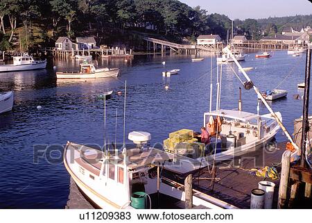 Stock Image -  New Harbor, Maine, ME, Pemaquid, Fishing boats, fishermen, dock, lobster traps in the harbor. . Fotosearch