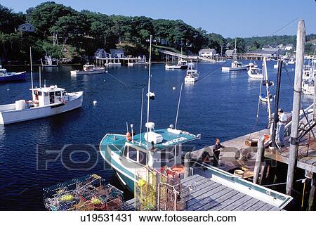 Stock Image -  New Harbor, Maine, ME, Pemaquid, Fishing boats, fishermen, dock, lobster traps in the harbor. . Fotosearch