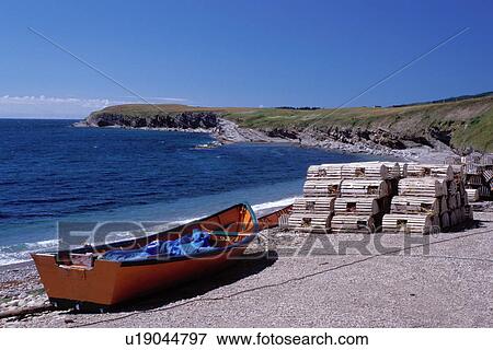 Newfoundland, NF, Canada, Orange fishing boat and lobster traps on the beach at Man Of War Cove on St. George's Bay at Port au Port Peninsula on Gulf of St. Lawrence. View Large Photo Image Stock Photo - Newfoundland, NF, Canada, Orange fishing boat and lobster traps on the beach at Man Of War Cove on St. George's Bay at Port au Port Peninsula on Gulf of St. Lawrence.. Fotosearch
