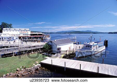 Stock Image -  NH, Weirs Beach, New Hampshire, Boardwalk, M. S. Mt. Washington Cruise Boat, Lake Winnipesaukee.. Fotosearch