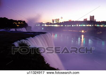 Stock Photo -  Niagara Falls, New York, NY, American Falls illuminated at night at Niagara Falls. . Fotosearch