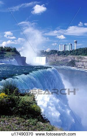 Stock Image -  Niagara Falls, NY, waterfalls, New York, American Falls with Canadian Falls (Horseshoe Falls) in the background at Niagara Falls. . Fotosearch