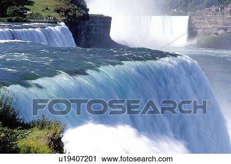 Stock Image -  Niagara Falls, NY, waterfalls, New York, American Falls with Canadian Falls in the background at Niagara Falls. . Fotosearch