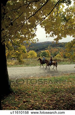 Stock Photo -  North Carolina, NC, People horseback riding in Moses H. Cone Memorial Park in the fall., . Fotosearch