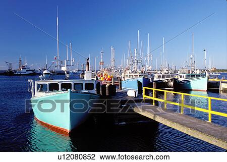 Stock Image -  Nova Scotia, Cape Sable Island, NS, Canada, Fishing boats docked in the harbor on Cape Sable Island on the Atlantic Ocean. . Fotosearch