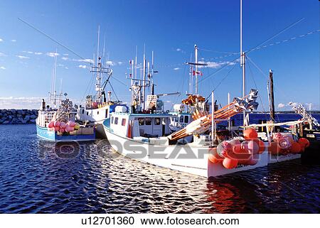Stock Image -  Nova Scotia, Cape Sable Island, NS, Canada, Fishing boats docked in the harbor on Cape Sable Island on the Atlantic Ocean. . Fotosearch