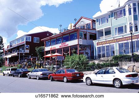 Stock Image -  Nova Scotia, Lunenburg, NS, Canada, Restaurants and hotels along the street in the scenic village of Lunenburg, UNESCO World Heritage Site, on the Atlantic Ocean. . Fotosearch