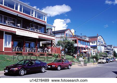 Stock Photo -  Nova Scotia, Lunenburg, NS, Canada, Restaurants and hotels along the street in the scenic village of Lunenburg, UNESCO World Heritage Site, on the Atlantic Ocean. . Fotosearch