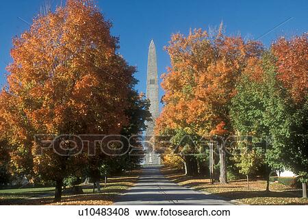 Stock Photo -  obelisk, fall, Bennington, VT, Vermont, Colorful foliage along the road that leads up to the Bennington Battle Monument a 306 foot structure in autumn in Bennington.. Fotosearch