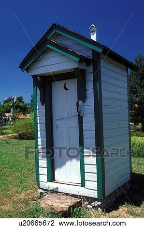 Stock Image -  outhouse, Carthage, MO, Missouri, White outhouse with green trim at Red Oak II a ghost town. . Fotosearch