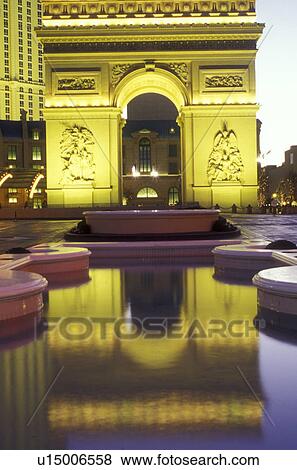 Stock Photo -  Paris Casino & Resort, Nevada, Las Vegas, NV, Replica of the Arc de Triomphe and other landmarks at Paris Las Vegas Resort & Casino on The Strip at night in Las Vegas, the Entertainment Capital of the World.. Fotosearch