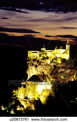 Stock Image -  Perigord, Dordogne, France, Rocamadour, Midi-Pyrenees, Lot, Europe, The fortified pilgrimage town of Rocamadour which cascades down the terraced limestone cliffs is illuminated at night. . Fotosearch