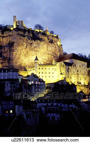 Stock Image -  Perigord, Rocamadour, Dordogne, France, Lot, Midi-Pyrenees, Europe, The fortified pilgrimage town of Rocamadour situated on the terraced limestone cliffs is illuminated at night. . Fotosearch