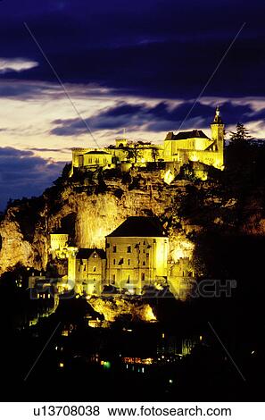 Perigord, Rocamadour, France, Dordogne, Midi-Pyrenees, Lot, Europe, The fortified pilgrimage town of Rocamadour which cascades down the terraced limestone cliffs is illuminated at night. View Large Photo Image Stock Photo - Perigord, Rocamadour, France, Dordogne, Midi-Pyrenees, Lot, Europe, The fortified pilgrimage town of Rocamadour which cascades down the terraced limestone cliffs is illuminated at night. . Fotosearch