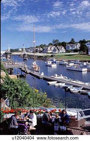 Picture -  Perkins Cove, outdoor cafT, Ogunquit, Maine, ME, People sitting on the terrace at Barnacle Billy's on the scenic fishing harbor in the village of Perkins Cove on the Atlantic Ocean. . Fotosearch