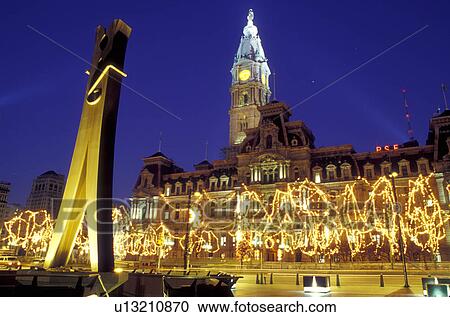 Stock Image -  Philadelphia, City Hall, clothespin, Pennsylvania, PA, The Clothespin statue outside City Hall at Center Square decorated for the Christmas holidays in downtown Philadelphia in the evening.. Fotosearch