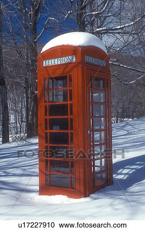 Stock Image -  phone booth, telephone booth, winter, snow, A red telephone booth stands out in a field of snow on a beautiful sunny day in winter in Dorset in Bennington County in the state of Vermont. . Fotosearch