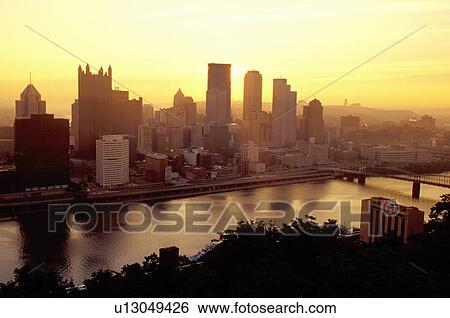 Stock Photograph -  Pittsburgh, PA, skyline, Pennsylvania, Aerial view of the downtown skyline of Pittsburgh at sunrise along the Monongahela River.. Fotosearch