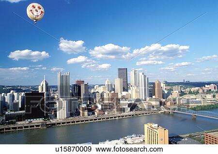 Pittsburgh, skyline, hot-air balloon, PA, Pennsylvania, Downtown skyline of Pittsburgh and pink pig hot-air balloon from the Three Rivers Regatta Festival along the Monongahela River. View Large Photo Image Stock Photo - Pittsburgh, skyline, hot-air balloon, PA, Pennsylvania, Downtown skyline of Pittsburgh and pink pig hot-air balloon from the Three Rivers Regatta Festival along the Monongahela River.. Fotosearch