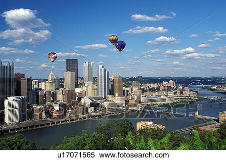 Stock Photography -  Pittsburgh, skyline, hot-air balloon, PA, Pennsylvania, Hot-air balloons from Three Rivers Regatta Festival hover over the downtown skyline of Pittsburgh along the Monongahela River.. Fotosearch