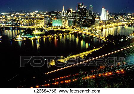 Stock Photograph -  Pittsburgh, skyline, PA, aerial, Pennsylvania, downtown skyline of Pittsburgh, Monongahela River, night. Incline tracks are illuminated.. Fotosearch
