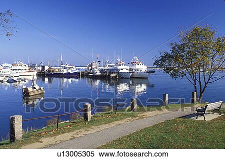 Stock Photography -  Plymouth, Massachusetts, MA, View of Captain John Whale Watching boats docked in Plymouth Harbor in Plymouth in the autumn.. Fotosearch
