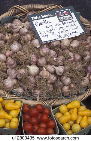 Stock Photography -  produce, vegetables, outdoor market, Vermont, VT, Garlic and other produce displayed in baskets for sale at the Saturday Farmers Market in Montpelier. . Fotosearch