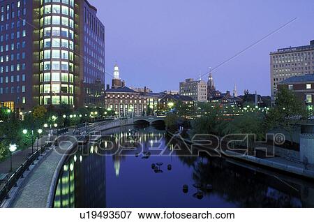 Stock Photo -  Providence, Waterplace Park, Rhode Island, RI, Buildings at night along the Woonasquatucket River at Waterplace Park in downtown Providence.. Fotosearch