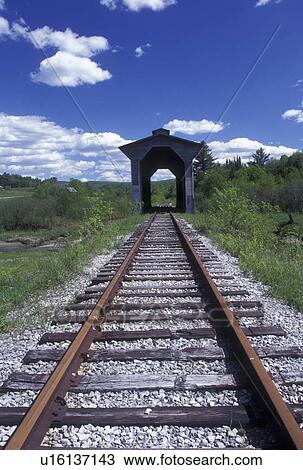 Stock Image -  railroad, covered bridge, spring, Wolcott, VT, Vermont, Fisher Covered Railroad Bridge circa 1908 in Wolcott in the spring.. Fotosearch