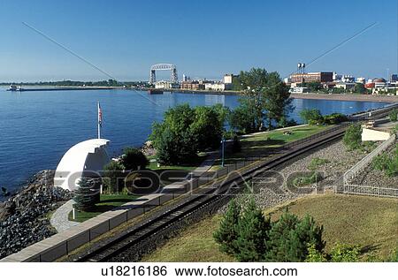 Stock Photograph -  railroad, train, Duluth, MN, Minnesota, North Shore Scenic Railroad and Vietnam Veterans Memorial along Lake Superior in Duluth.. Fotosearch