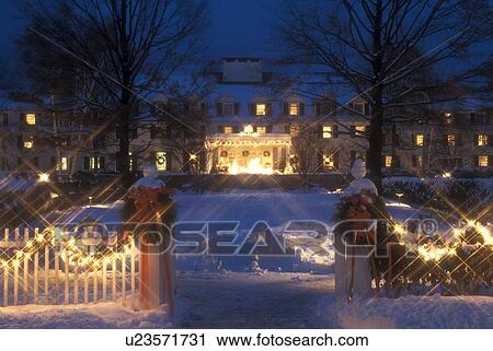 Stock Image -  Resort, Inn, hotel, B&B, Christmas, holiday, decorations, snow, winter, The Woodstock Inn & Resort is decorated with lights for the Christmas holiday season at night in the village of Woodstock in Windsor County in the state of Vermont. . Fotosearch
