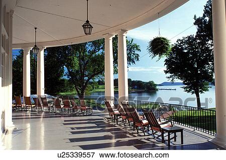 Stock Photo -  resort, rocking chairs, Cooperstown, New York, Rocking chairs on the porch of The Otesaga Resort Hotel overlooking Otsego Lake in Cooperstown, NY.. Fotosearch