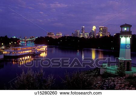 riverboat, skyline, Minneapolis, MN, Minnesota, Twin Cities, Lighthouse and riverboats illuminated at night at Boom Island Park along the Mississippi River. Downtown skyline in the background. View Large Photo Image Stock Image - riverboat, skyline, Minneapolis, MN, Minnesota, Twin Cities, Lighthouse and riverboats illuminated at night at Boom Island Park along the Mississippi River. Downtown skyline in the background.. Fotosearch