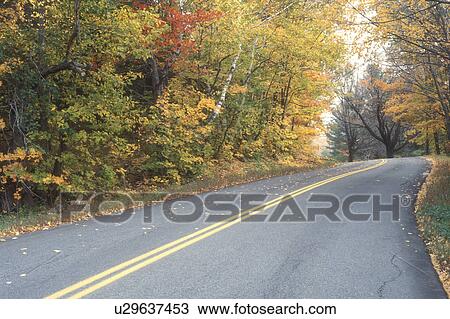 Stock Image -  road, fall, Tinmouth, VT, Vermont, Colorful fall foliage along Route 140 in autumn.. Fotosearch