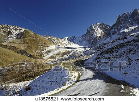 Stock Image -  road, The Pyrenees, Col du Tourmalet, France, Midi-Pyrenees, Hautes-Pyrenees, Europe, A mountain road winds up through the jagged snow capped Pyrenees Mountains in Col-du-Tourmalet.. Fotosearch