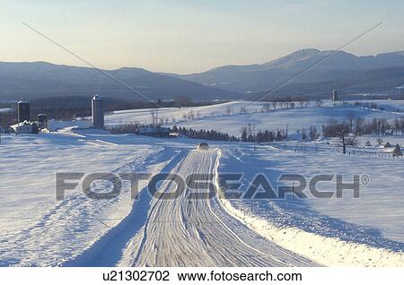 Stock Image -  road, Vermont, Newport, VT, Scenic countryside, snow-covered, country road, farmland, winter.. Fotosearch