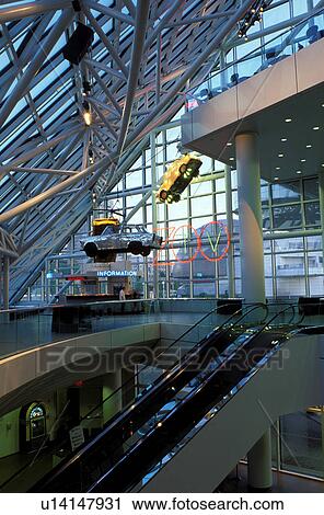 Stock Image -  rock 'n roll, hall of fame, interior, Cleveland, OH, Ohio, Cars hang form the ceiling inside the Rock and Roll Hall of Fame and Museum.. Fotosearch