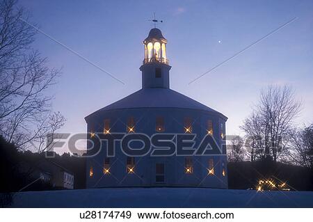 Stock Photo -  round church, Christmas, chapel, winter, decorations, snow, Vermont, Candles in the windows decorate the Old Round Church (a 16-sided polygon) National Historical Landmark for the Christmas holiday season at night in Richmond in Chittenden County in the . Fotosearch